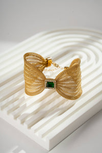 Bracelet manchette dorés en maille avec nœud bijou central